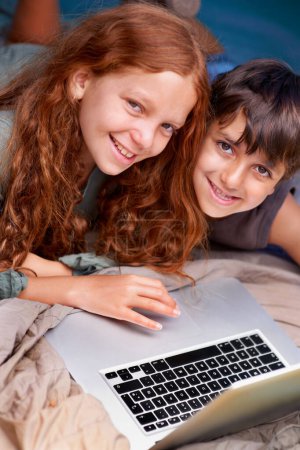 Photo for Children, relax and portrait with laptop on floor together with happiness and online games for holiday or vacation. Kids, smile and playing with computer on website, streaming or search on internet. - Royalty Free Image