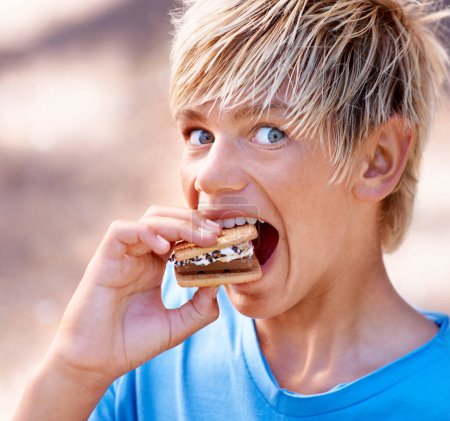 Photo for Child, portrait and marshmallow smores or outdoor for dessert snack, adventure or summer. Boy, kid and face smile with chocolate or cookie for fire cooking or hungry for candy, sweet or environment. - Royalty Free Image
