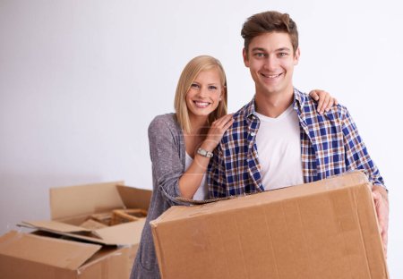 Photo for Couple, moving and new home with box for packing, happy with real estate and support with smile in portrait. Property, investment and people with cardboard package for relocation, mortgage or rent. - Royalty Free Image