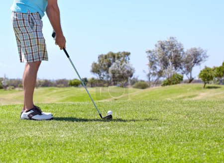 Photo for Man, golf club and ball on green grass, field or lawn for sports, shot or ready to strike on course. Closeup of male person, golfer or player legs in stance with stick for score or point in nature. - Royalty Free Image