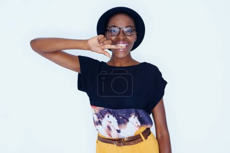 Photo for Portrait, fashion and glasses with happy black woman in studio on white background for style. Model, smile and accessories with confident young hipster person biting finger in trendy clothes outfit. - Royalty Free Image