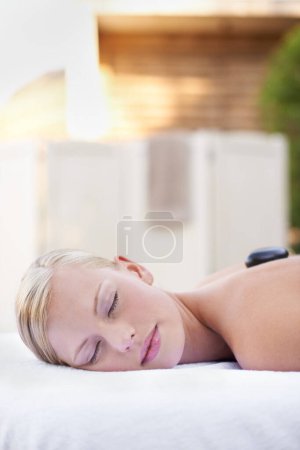 Photo for Spa, woman and sleeping on massage bed with smile for wellness, mock up and beauty treatment for body care. Person, relax and physical therapy at resort, salon table and luxury on holiday or vacation. - Royalty Free Image