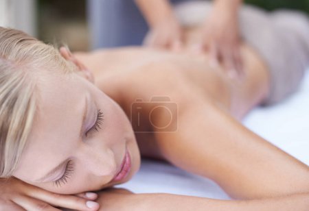 Photo for Woman, massage therapist and spa for treatment, back and sleeping for wellness and stress relief therapy. Face, masseuse and relaxing in resort, peaceful and hands for luxury body care or tranquility. - Royalty Free Image