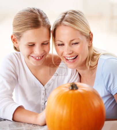 Photo for Child, mother and smile with pumpkin to celebrate halloween party together at home. Happy young girl, mom and family carving orange vegetable for holiday lantern, decoration and fun creative craft. - Royalty Free Image