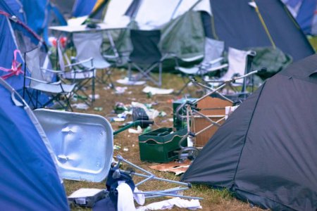 Photo for Tents, trash and mess at an outdoor music festival or event for a celebration party or social gathering. Summer, campsite and dirty with untidy camping gear, chairs or cooler boxes on the ground. - Royalty Free Image