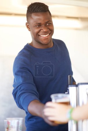 Photo for Smile, party and a black man bartender serving drinks outdoor at an event, festival or celebration. Beer, alcohol and carnival with a happy young person at a bar in a tent for beverage service. - Royalty Free Image