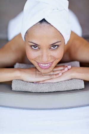 Photo for Spa, woman and happy on massage bed with portrait for wellness, zen and beauty treatment for body care. Person, face and physical therapy at resort, salon table and relax on holiday or vacation. - Royalty Free Image