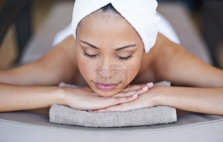 Photo for Young woman, relax or sleeping in spa on massage table, beauty or wellness for body treatment in salon. Person, rest and zen for health at luxury resort, calm and comfort for stress free on holiday. - Royalty Free Image