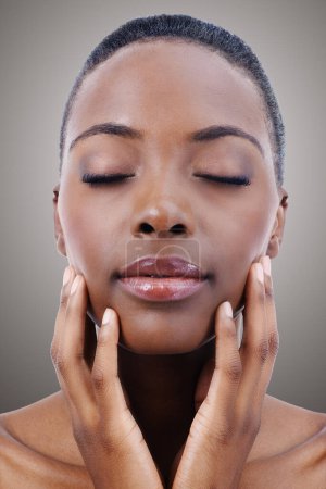 Photo for Face, beauty and relax with natural black woman in studio on gray background or wellness aesthetic. Skincare, makeup and cosmetics with young person at spa for facial treatment or dermatology. - Royalty Free Image