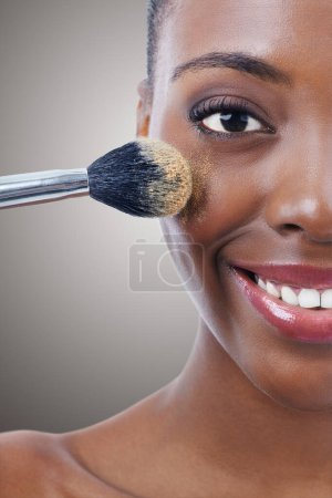 Photo for Brush, makeup and black woman, portrait and beauty with foundation for cosmetics, wellness and cropped on grey background. Shine, cosmetology and tools to apply powder, glow and shimmer in studio. - Royalty Free Image