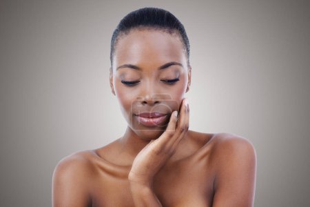 Photo for Woman, skincare and natural wellness in studio for healthy cosmetics for dermatology, beauty or grey background. Black person, model and thinking in Kenya or glowing makeup, treatment or mockup space. - Royalty Free Image