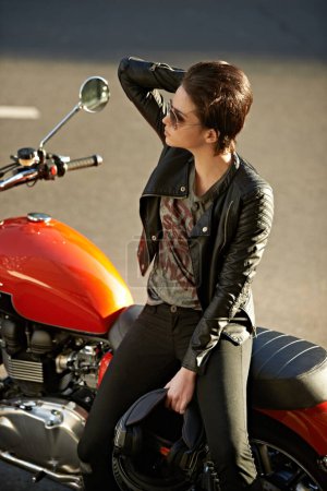 Photo for Motorcycle, street and woman in city with sunglasses for travel, transport or road trip as rebel. Fashion, leather and model with attitude on classic or vintage bike for transportation or journey. - Royalty Free Image