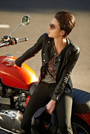 Photo for Motorcycle, thinking and woman in city with sunglasses for travel, transport or road trip as rebel. Fashion, leather and model with attitude on classic or vintage bike for transportation or journey. - Royalty Free Image