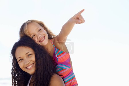 Photo for Happy mother, child and pointing on piggyback at beach for exploring or sight on mockup space. Face of mom, daughter or kid smile for vision, adventure or looking in a distance on a sky background. - Royalty Free Image