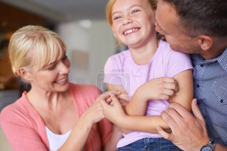 Photo for Family, laughing and parents tickling daughter in living room of home for playful bonding together. Kids, happy or love with mother, father and girl child playing in apartment for comedy or humor. - Royalty Free Image