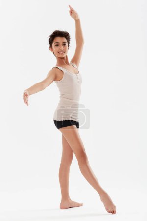 Photo for Dance, ballerina and portrait of girl on a white background for performance, fitness and training for theatre. Ballet, dancer and isolated person for balance, creative routine and practice in studio. - Royalty Free Image
