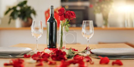 Photo for Wine, flowers and romance on valentines day for celebration of love, anniversary or honeymoon in still life. Glass, dinner and elegant date in dining room of home for event, milestone or occasion. - Royalty Free Image