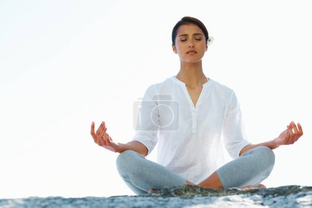 Foto de Mujer, meditación y yoga en zen para el bienestar espiritual, la conciencia o la playa al aire libre con fondo de cielo. Calma persona femenina o yogui meditando para la paz interior, la respiración o la salud en el espacio de maqueta. - Imagen libre de derechos