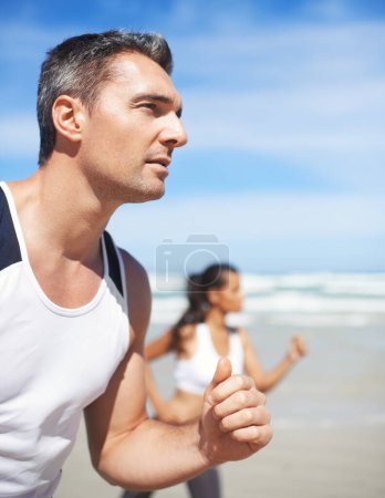 Téléchargez les photos : Mature, homme ou personne sur la plage courir pour l'exercice, l'entraînement ou l'entraînement en plein air en mer. Couple sportif, coureurs ou athlètes en bonne santé dans la nature pour l'endurance de remise en forme, bien-être ou défi sur sable. - en image libre de droit