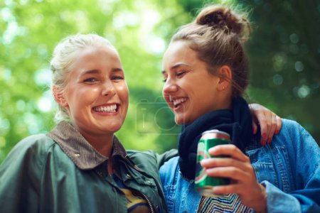 Photo for Portrait, music festival and women with a beer, hug and excited with happiness and bonding together. Face, people or outdoor with friends and alcohol with weekend break and smile with embrace and can. - Royalty Free Image