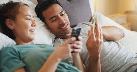 Photo for Phone, couple and video mobile streaming of people in bed looking at social media app content. Internet, technology and bedroom web scroll of a girlfriend and boyfriend at home look at a funny meme. - Royalty Free Image