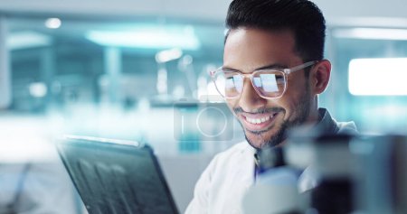 Photo for Tablet, Asian man or scientist with research in laboratory for a chemistry report or medical test feedback. Happy, person reading or science update for online medicine development news on website. - Royalty Free Image
