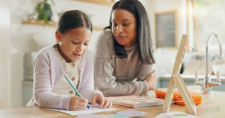 Photo for Homework, mother and girl with education, teaching and conversation with support, help and knowledge. Female child writing, student or mama with a kid, kitchen and learning with growth or development. - Royalty Free Image