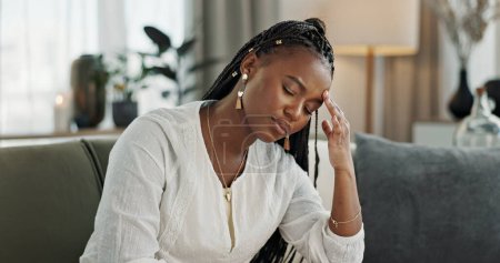 Photo for Headache, burnout and young black woman in the living room of her modern apartment on weekend. Stress, mental health and sick African female person with migraine for illness in lounge at home - Royalty Free Image