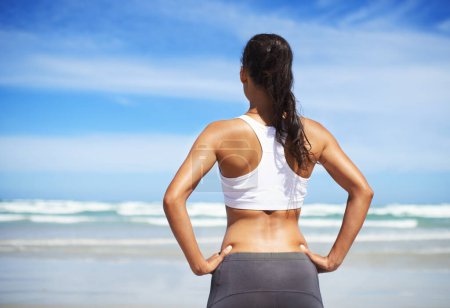 Photo for Back, beach and woman with fitness, vacation and training with summer break or sunshine with water. Person, seaside or runner with workout or practice with fresh air or athlete with wellness or waves. - Royalty Free Image