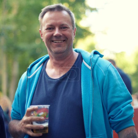 Photo for Portrait, beer and man at outdoor party, celebration or happy adventure at holiday event in Germany. Smile, drinks and nature, mature person on vacation to relax with alcohol at Munich festival - Royalty Free Image