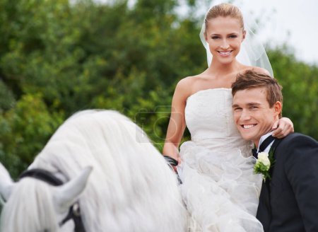 Photo for Couple, marriage and horse with nature, countryside and celebration for love, portrait and smile. Groom, wife and uk forest with happiness, wedding and horse riding for honeymoon, vacation or holiday. - Royalty Free Image