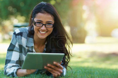 Photo for College, woman and portrait with tablet in park for research, project or learning outdoor on campus. University, student and girl streaming online with ebook, education or studying on grass in garden. - Royalty Free Image