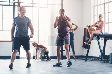 Photo for Success is a series of small wins. Shot of a fitness group celebrating a victory at the gym - Royalty Free Image