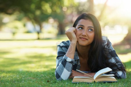 Photo for Happy woman, student and thinking with book for reading, literature or studying on green grass. Young or thoughtful female person with smile in wonder for chapter, learning or outdoor story in nature. - Royalty Free Image