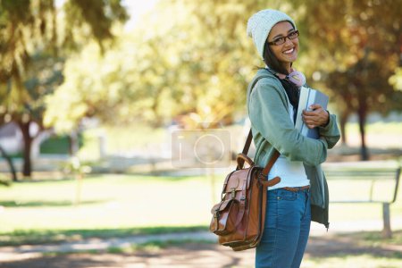 Photo for Park, student and portrait of woman with books for studying, learning and reading outdoors. Education, happy and person with bag, textbooks and headphones relax on campus for university or college. - Royalty Free Image