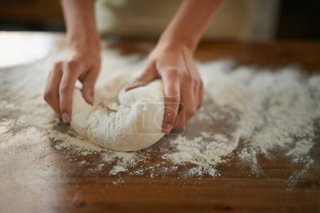 Photo for Hands, dough and wheat flour on table at bakery, bread or pizza with meal prep, catering and cooking. Culinary, chef or baker person with pastry preparation, ingredients and food for nutrition. - Royalty Free Image