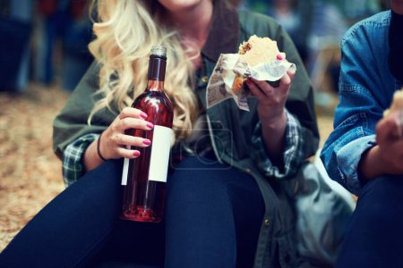 Photo for Snack, woman and music festival with friends, beer and happiness with joy and bonding together. Alcohol, outdoor and girl with fast food or takeaway with summer break or concert with culture or event. - Royalty Free Image