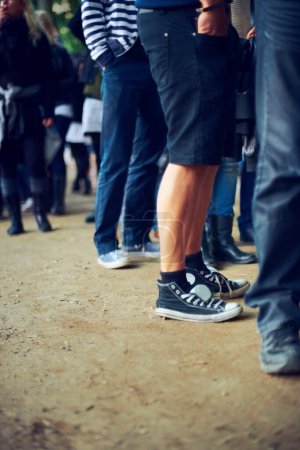 Photo for People, feet and music festival in nature to party, social and youth in trendy fashion at event. Group, legs or community in denim jeans at carnival, culture or crowd by reunion celebration in forest. - Royalty Free Image
