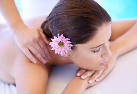 Photo for Rest, massage and woman at spa with flower for health, wellness balance and luxury holistic treatment. Self care, peace and girl on table with masseuse for body therapy, relax and calm hotel service. - Royalty Free Image