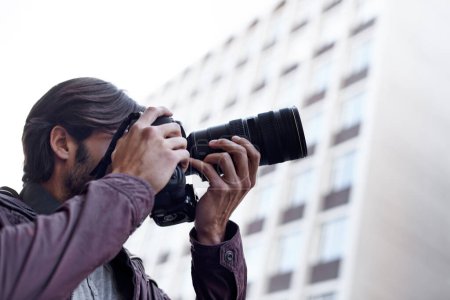 Photo for Photographer, work and paparazzi man in city for press, travel and filming memory of adventure with camera. Professional, cameraman and capture creative photography with lens outdoor in photoshoot. - Royalty Free Image
