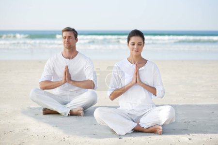 Photo for Lotus, yoga and couple on beach in morning for fitness, exercise and mindfulness with prayer hands. Nature, love and man and woman by ocean for meditation, wellness and healthy body outdoors together. - Royalty Free Image