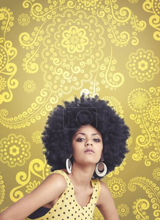 Photo for African woman, afro and vintage in studio, fashion and bold expression on face, unique and dots in clothes. Retro, hair and person with confidence, yellow background and portrait of cool girl. - Royalty Free Image