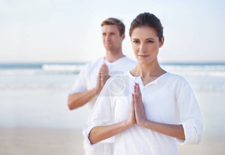 Photo for Prayer, yoga and couple on beach in morning for fitness, exercise and mindfulness in lotus pose. Nature, love and man and woman by ocean for meditation, wellness and healthy body outdoors together. - Royalty Free Image