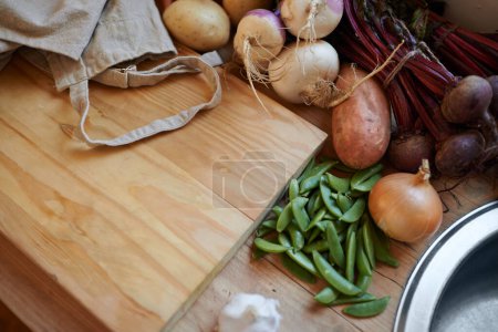 Photo for Vegetables, vegan and wooden board for cooking lunch, dish and nutrition for diet at home. Wellness, health and organic food with meal, vegetarian and green ingredients for salad in a kitchen. - Royalty Free Image