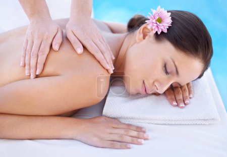 Photo for Relax, massage and woman at spa pool with flower for health, wellness and luxury holistic treatment. Self care, peace and girl on table with masseuse for body therapy, sleep and calm hotel service. - Royalty Free Image