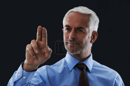 Photo for Business man, finger and press interface for choice isolated on a black studio background. Touch, professional and hand gesture on screen, click and future innovation of technology for senior CEO. - Royalty Free Image