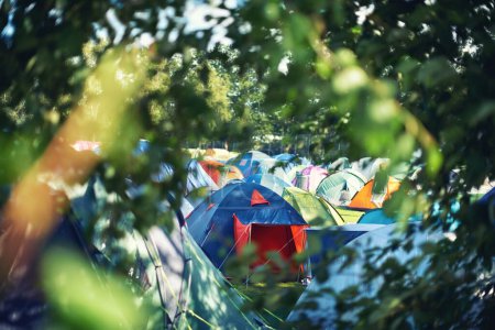 Photo for Many tents, camping and outdoor in nature for a music festival. Row of rainbow marquees placed on ground at musical soiree, entertainment event and carnival celebration, relax on holiday campsite. - Royalty Free Image