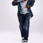 Child, smile and dancing with hiphop and street style clothing in a studio with boy dancer. Trendy, energy and cool African kid with youth and rap music with white background and gen z clothes.