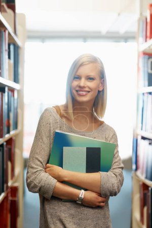 Photo for Woman, library and books, portrait for education and knowledge with smile on campus. College student, bookstore and reading material for learning, happy with university and academic development. - Royalty Free Image