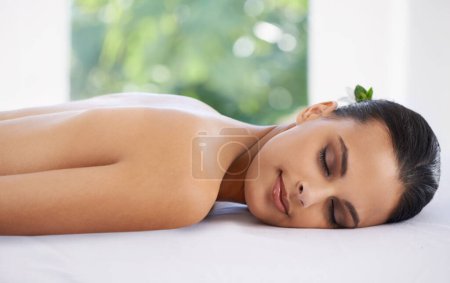 Photo for Relax, calm and woman at spa for skincare, massage and peace at table to rest for zen at luxury resort. Beauty, therapy and young person at salon for healthy body, treatment and pamper for wellness. - Royalty Free Image